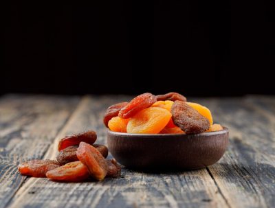 dried-apricots-clay-bowl-wooden-table_176474-5450