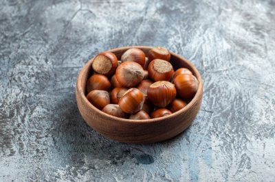 front-view-fresh-hazelnuts-inside-plate-white-background_140725-89502
