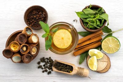 top-view-cup-tea-with-lemon-mint-cinnamon-white-tea-dessert-candy_140725-25007