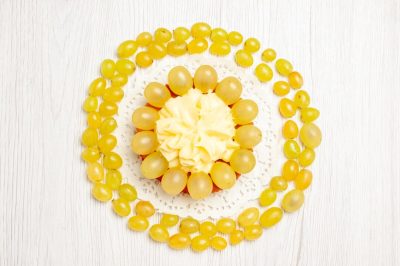 top-view-yummy-creamy-cake-with-fresh-green-grapes-white-desk-fruit-cream-cake-biscuit-cookie_140725-118423